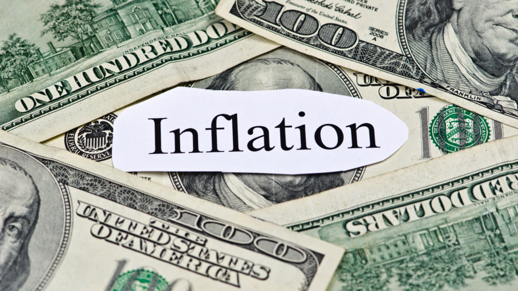 the word inflation on a backdrop of cash